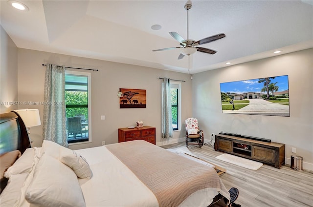 17809 Southwick Way, Boca Raton, FL 33498 - bedroom with multiple windows, light wood-type flooring, a tray ceiling, recessed lighting, and ceiling fan