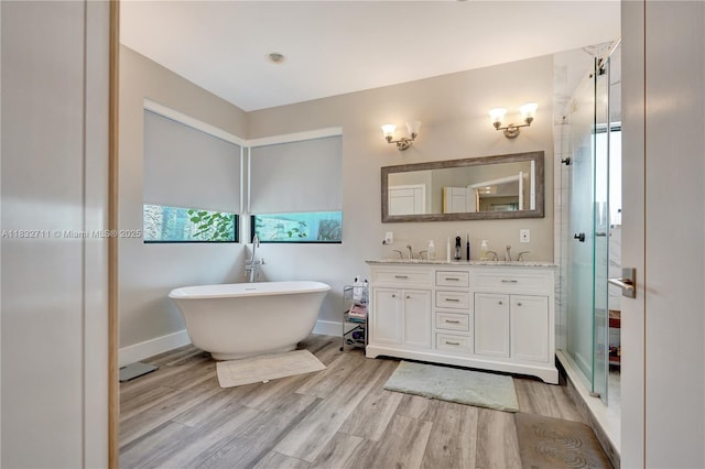 17809 Southwick Way, Boca Raton, FL 33498 - bathroom with double vanity, a stall shower, wood finished floors, and a freestanding bath