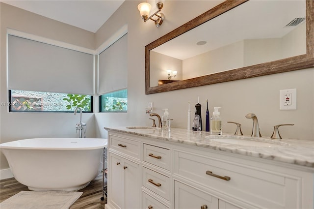 17809 Southwick Way, Boca Raton, FL 33498 - bathroom featuring double vanity, wood finished floors, and a freestanding tub