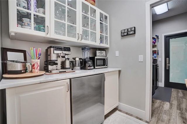 17809 Southwick Way, Boca Raton, FL 33498 - bar featuring stainless steel appliances and light wood-style flooring