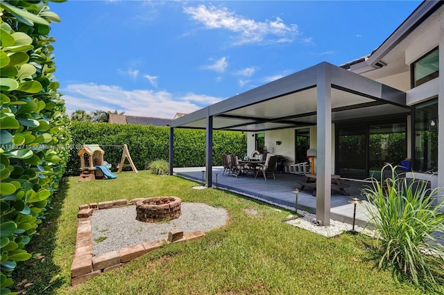 17809 Southwick Way, Boca Raton, FL 33498 - view of grassy yard with a fire pit, a patio, and a playground