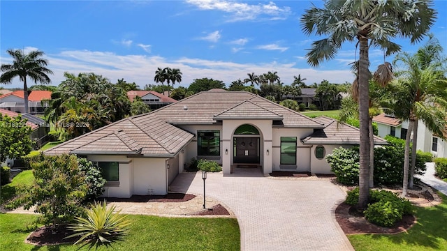 17809 Southwick Way, Boca Raton, FL 33498 - view of front of property featuring decorative driveway, a tiled roof, stucco siding, and a garage