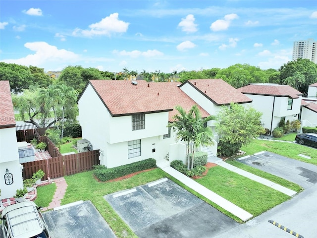 640 NW 98th Ct Unit 640, Miami, FL 33172 - view of front of house featuring uncovered parking, stucco siding, and a shingled roof