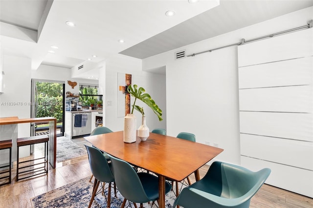 640 NW 98th Ct Unit 640, Miami, FL 33172 - dining room featuring recessed lighting, light wood-type flooring, and a barn door