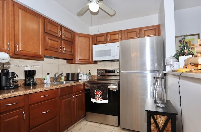 900 SW 11th Ave Unit C, Hallandale Beach, FL 33009 - kitchen featuring stainless steel appliances, a ceiling fan, backsplash, and light tile patterned flooring
