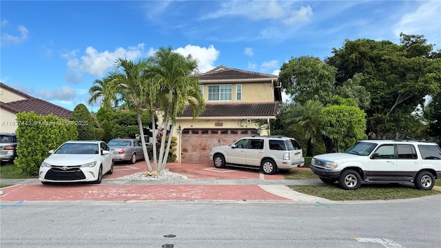 15588 SW 62nd St, Miami, FL 33193 - view of front of house with stucco siding, an attached garage, a tile roof, and driveway