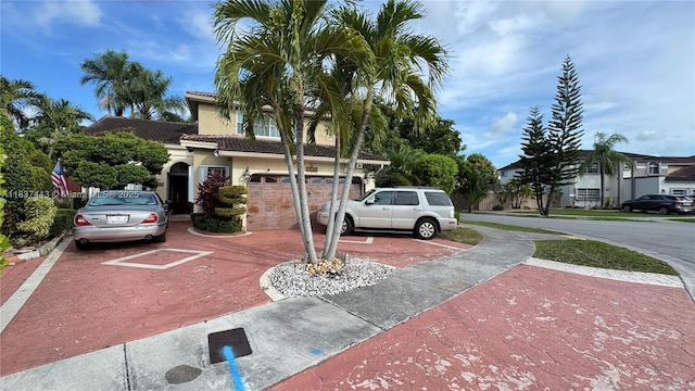 15588 SW 62nd St, Miami, FL 33193 - view of front of property with a tile roof, stucco siding, driveway, and an attached garage