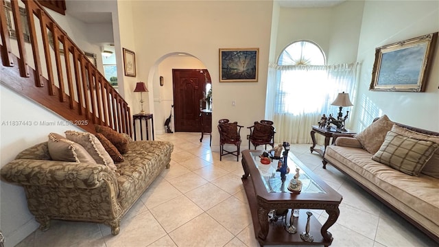 15588 SW 62nd St, Miami, FL 33193 - living area with a towering ceiling, arched walkways, light tile patterned flooring, and stairway