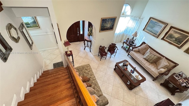 15588 SW 62nd St, Miami, FL 33193 - living area with arched walkways, light tile patterned flooring, and stairs