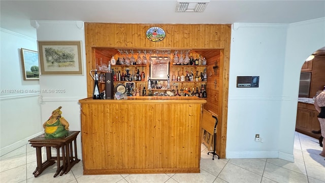 15588 SW 62nd St, Miami, FL 33193 - indoor dry bar featuring arched walkways, crown molding, tile patterned flooring, and refrigerator