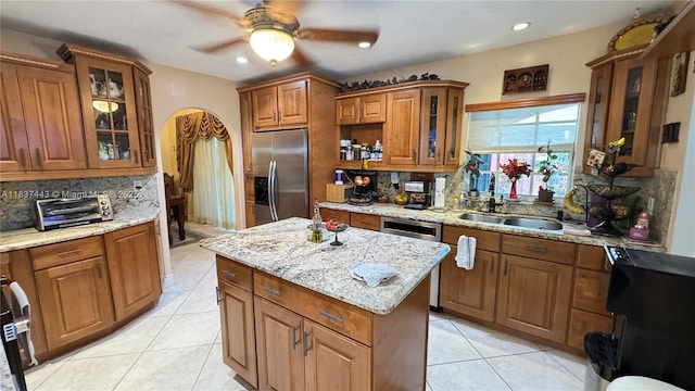 15588 SW 62nd St, Miami, FL 33193 - kitchen with stainless steel appliances, backsplash, brown cabinets, light tile patterned flooring, and recessed lighting