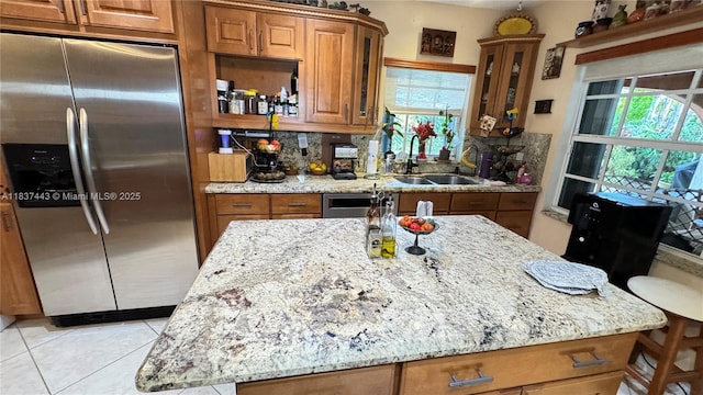 15588 SW 62nd St, Miami, FL 33193 - kitchen featuring stainless steel fridge with ice dispenser, brown cabinets, and light stone countertops
