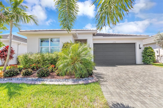 15734 SW Egret Coast Dr, Port St Lucie, FL 34987 - single story home featuring stucco siding, a garage, decorative driveway, and a tile roof