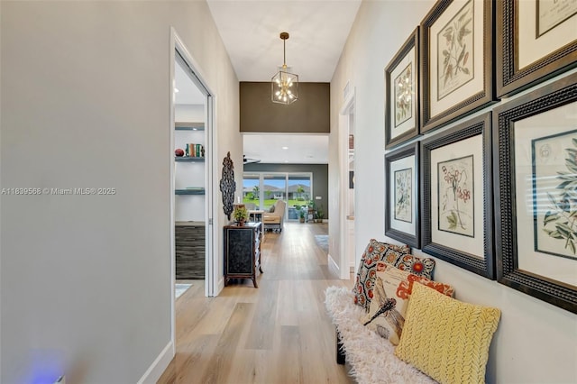 15734 SW Egret Coast Dr, Port St Lucie, FL 34987 - hall with a chandelier and light wood-style flooring