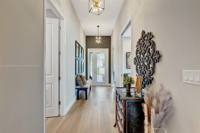 15734 SW Egret Coast Dr, Port St Lucie, FL 34987 - entrance foyer with a chandelier and light wood-style floors