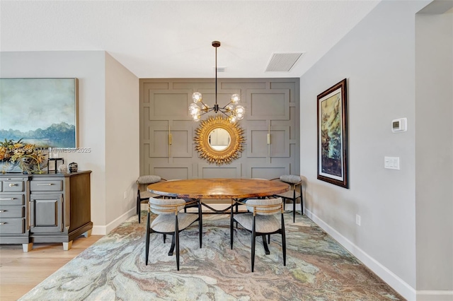 15734 SW Egret Coast Dr, Port St Lucie, FL 34987 - dining area featuring a chandelier and light wood-style floors