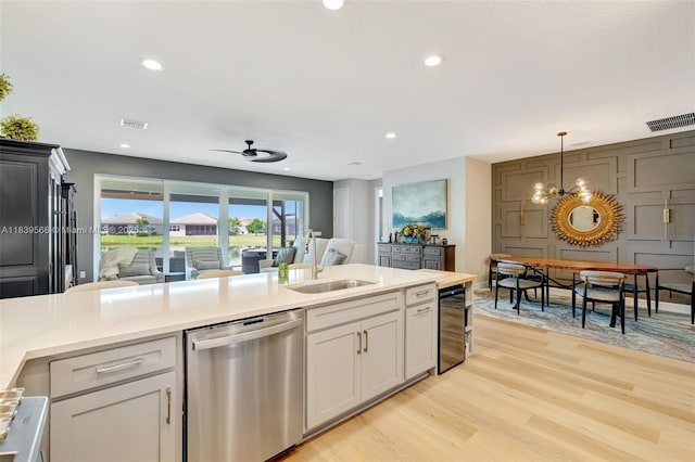 15734 SW Egret Coast Dr, Port St Lucie, FL 34987 - kitchen with dishwasher, light wood finished floors, open floor plan, light countertops, and a ceiling fan