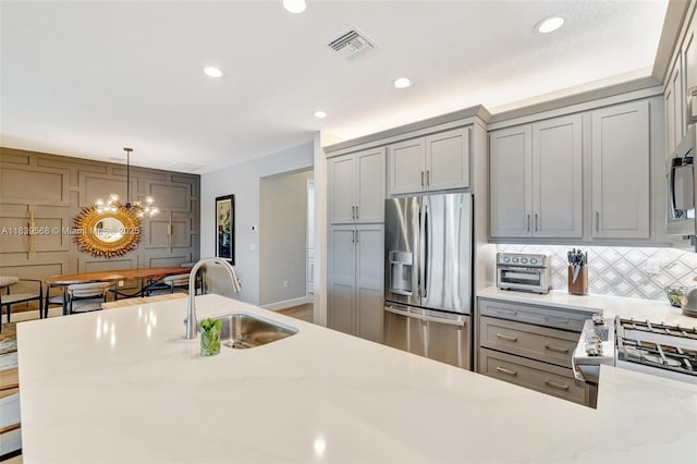 15734 SW Egret Coast Dr, Port St Lucie, FL 34987 - kitchen featuring stainless steel fridge, gray cabinetry, light countertops, and recessed lighting