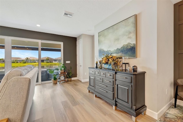 15734 SW Egret Coast Dr, Port St Lucie, FL 34987 - sitting room with light wood finished floors and recessed lighting