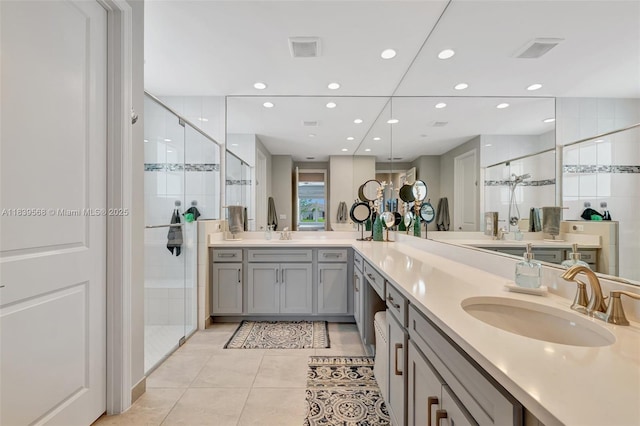 15734 SW Egret Coast Dr, Port St Lucie, FL 34987 - full bath with a stall shower, tile patterned floors, double vanity, and recessed lighting