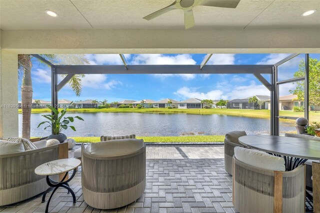 15734 SW Egret Coast Dr, Port St Lucie, FL 34987 - view of patio with a ceiling fan, a water view, a residential view, and glass enclosure