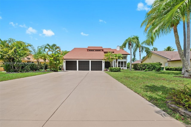 7545 Banyan Way, Tamarac, FL 33321 - view of front of house featuring a tiled roof, an attached garage, concrete driveway, a front yard, and a chimney