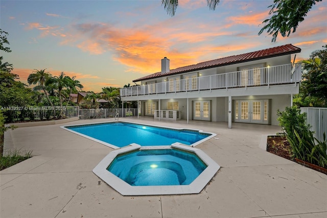 7545 Banyan Way, Tamarac, FL 33321 - view of swimming pool featuring french doors, a pool with connected hot tub, and a patio area