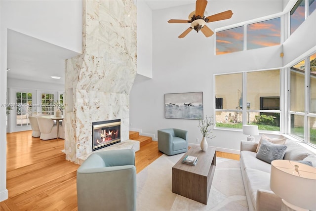 7545 Banyan Way, Tamarac, FL 33321 - living room featuring a high ceiling, wood finished floors, a ceiling fan, and a high end fireplace