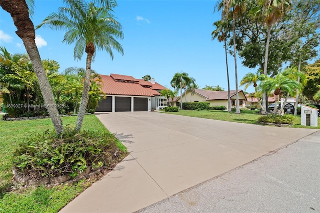 7545 Banyan Way, Tamarac, FL 33321 - view of front facade with an attached garage, driveway, a front yard, a tiled roof, and stucco siding