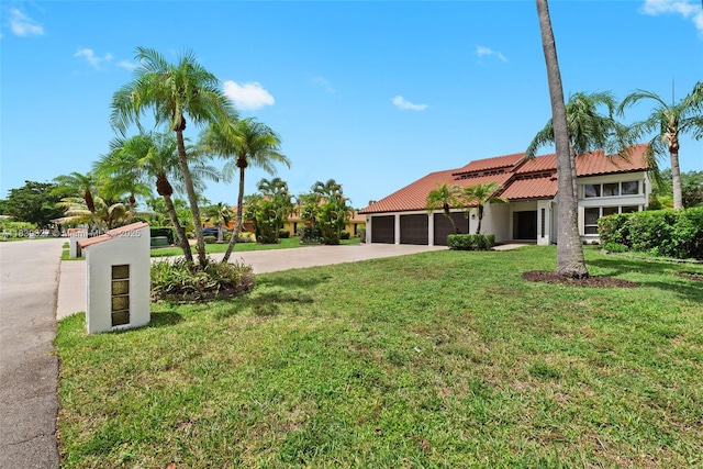 7545 Banyan Way, Tamarac, FL 33321 - view of grassy yard with driveway and a garage