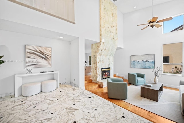 7545 Banyan Way, Tamarac, FL 33321 - living area with a towering ceiling, a high end fireplace, a ceiling fan, marble finish flooring, and recessed lighting