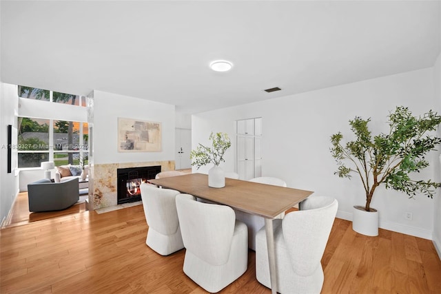 7545 Banyan Way, Tamarac, FL 33321 - dining area featuring a fireplace and light wood finished floors