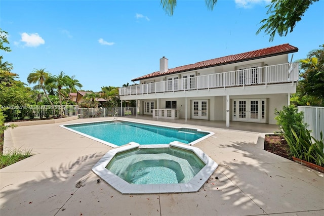 7545 Banyan Way, Tamarac, FL 33321 - view of swimming pool featuring french doors, a patio, and a pool with connected hot tub