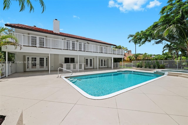 7545 Banyan Way, Tamarac, FL 33321 - view of swimming pool featuring french doors, a patio area, and a pool with connected hot tub