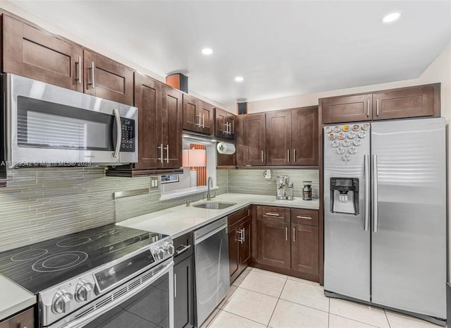 8415 SW 107th Ave Unit 130W, Miami, FL 33173 - kitchen with appliances with stainless steel finishes, light tile patterned flooring, tasteful backsplash, light countertops, and recessed lighting