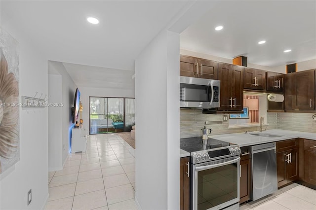 8415 SW 107th Ave Unit 130W, Miami, FL 33173 - kitchen featuring appliances with stainless steel finishes, light countertops, light tile patterned floors, backsplash, and recessed lighting
