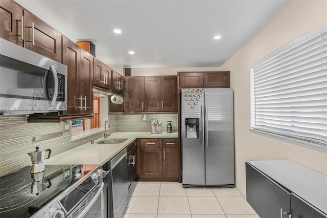 8415 SW 107th Ave Unit 130W, Miami, FL 33173 - kitchen with stainless steel appliances, tasteful backsplash, light tile patterned floors, dark brown cabinetry, and light countertops