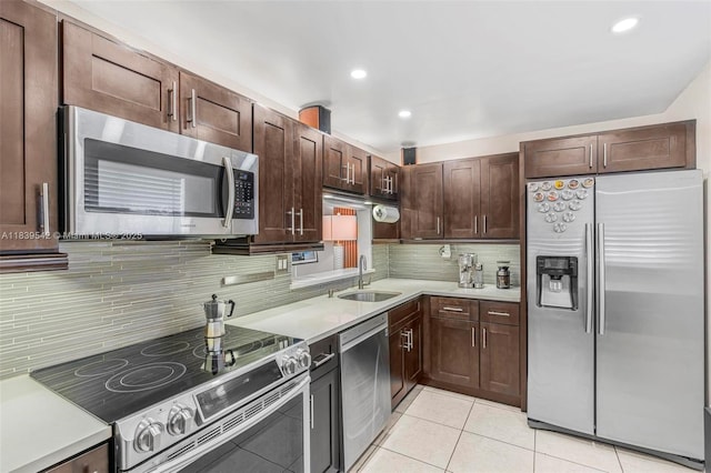 8415 SW 107th Ave Unit 130W, Miami, FL 33173 - kitchen with appliances with stainless steel finishes, light countertops, backsplash, light tile patterned floors, and recessed lighting