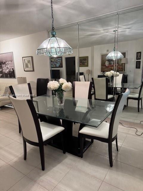 901 SW 141st Ave Unit 405M, Pembroke Pines, FL 33027 - dining room featuring light tile patterned floors and a chandelier