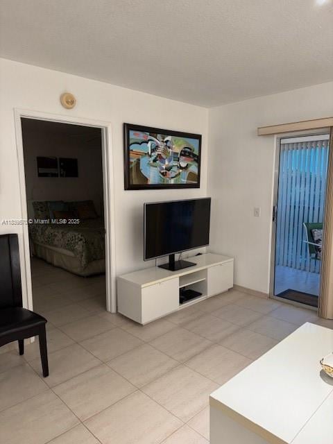 901 SW 141st Ave Unit 405M, Pembroke Pines, FL 33027 - living area featuring light tile patterned floors and baseboards