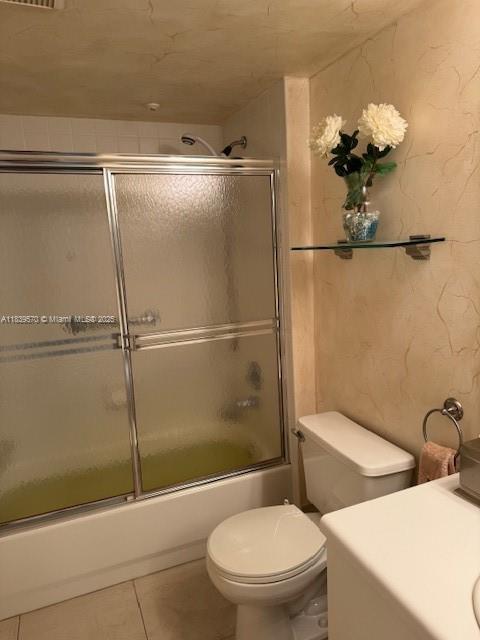 901 SW 141st Ave Unit 405M, Pembroke Pines, FL 33027 - bathroom featuring vanity, shower / bath combination with glass door, and tile patterned flooring