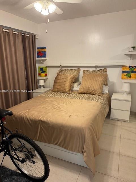 901 SW 141st Ave Unit 405M, Pembroke Pines, FL 33027 - bedroom with light tile patterned floors and ceiling fan