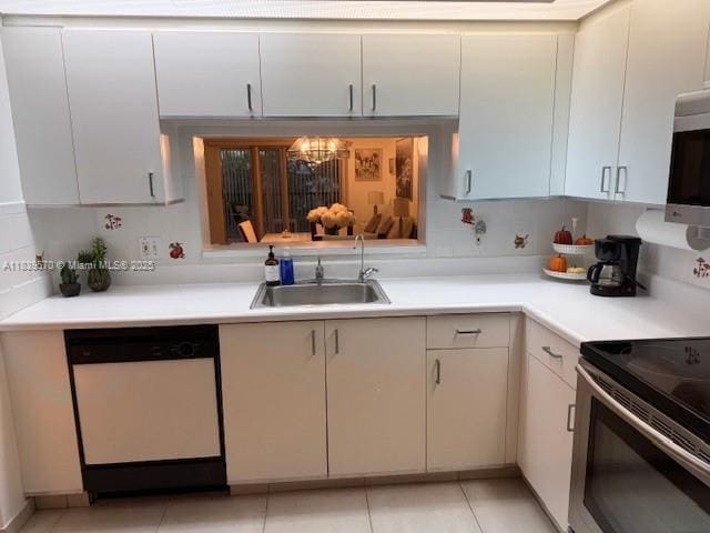 901 SW 141st Ave Unit 405M, Pembroke Pines, FL 33027 - kitchen featuring stainless steel appliances, light countertops, a chandelier, and light tile patterned floors