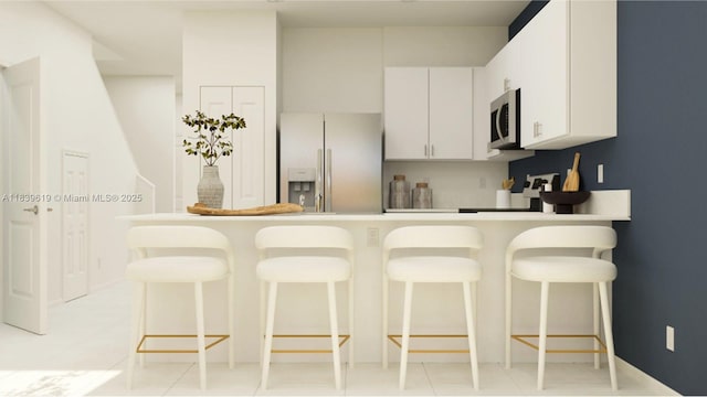 35713 SW 178th Ct, Miami, FL 33034 - kitchen featuring fridge with ice dispenser, stainless steel microwave, a peninsula, a kitchen breakfast bar, and light countertops