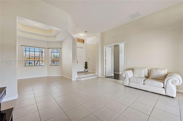 109 SW 128th Ave, Plantation, FL 33325 - unfurnished living room with light tile patterned floors and a raised ceiling