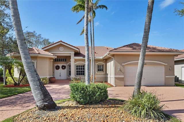109 SW 128th Ave, Plantation, FL 33325 - mediterranean / spanish-style home featuring a tile roof, stucco siding, a garage, and driveway