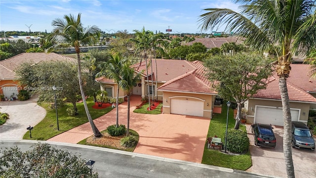 109 SW 128th Ave, Plantation, FL 33325 - mediterranean / spanish-style house featuring stucco siding, driveway, a tiled roof, and an attached garage