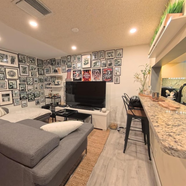 16652 Hemingway Dr, Weston, FL 33326 - living room featuring wood finished floors, recessed lighting, and a textured ceiling