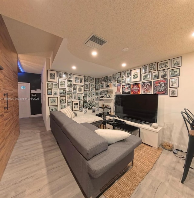 16652 Hemingway Dr, Weston, FL 33326 - living area with wood finished floors, a textured ceiling, and recessed lighting