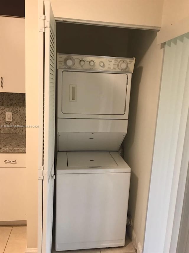 16652 Hemingway Dr, Weston, FL 33326 - laundry area featuring stacked washer / drying machine and light tile patterned floors